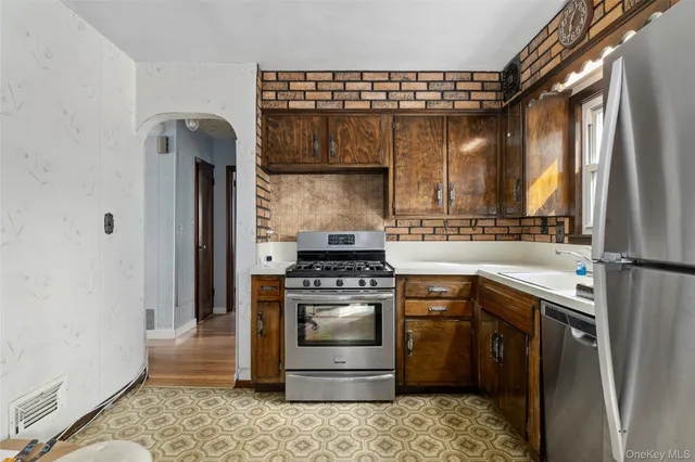 a kitchen with a stove and a refrigerator