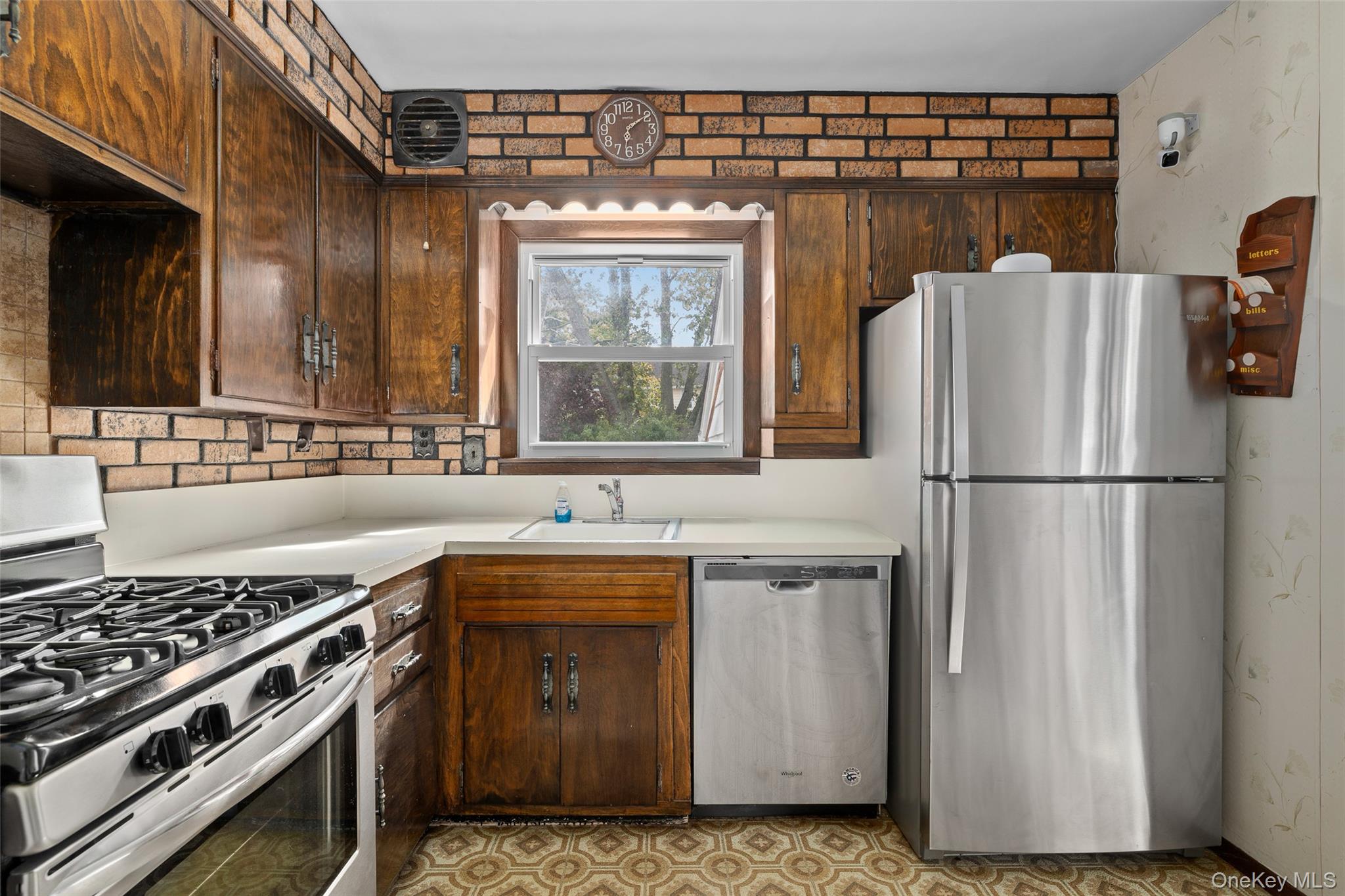 2975 Oceanside Road Oceanside, NY 11572 - Photo 15 of 26 a kitchen with stainless steel appliances granite countertop a sink stove and refrigerator