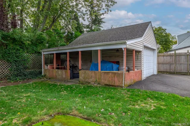 a view of a house with a yard and sitting area