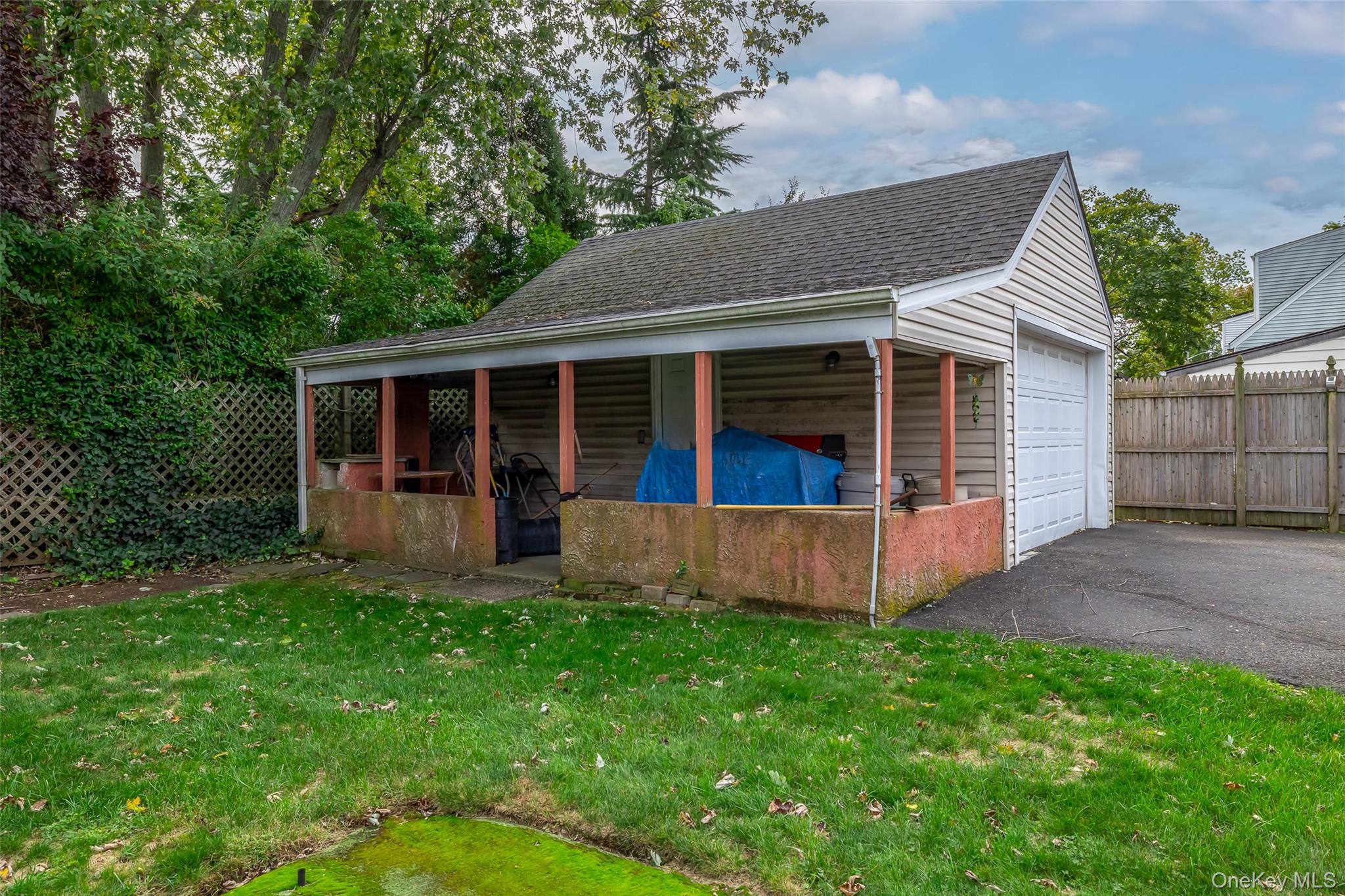 2975 Oceanside Road Oceanside, NY 11572 - Photo 26 of 26 a view of a house with a yard and sitting area