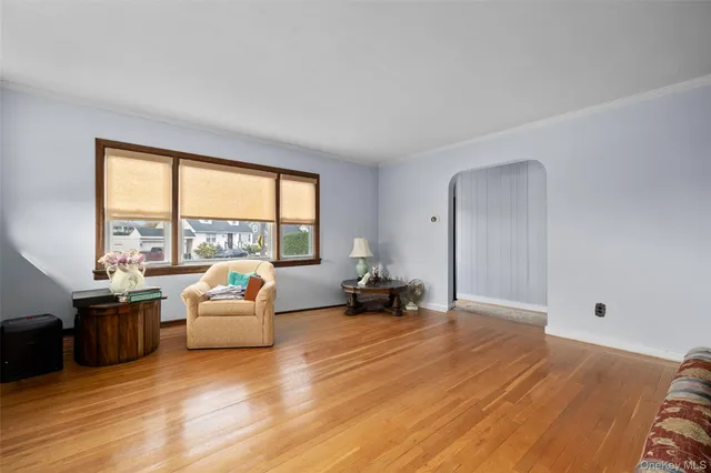 a living room with furniture and large windows