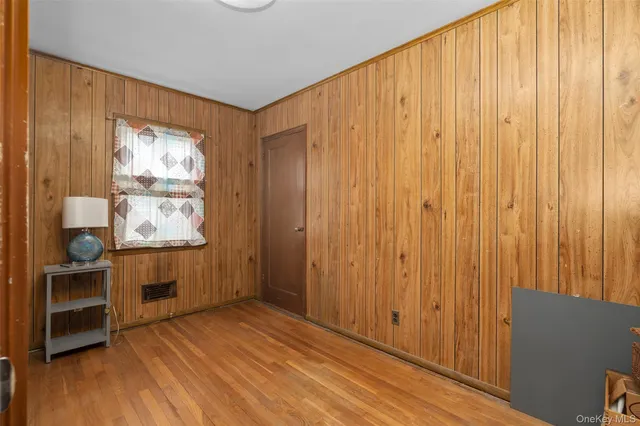 a view of a room with wooden floor and furniture