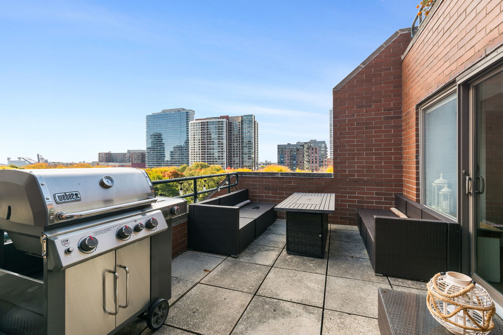 801 South Plymouth Court, Unit 602 Chicago, IL 60605 - Photo 7 of 15 a roof deck with couches and wooden floor