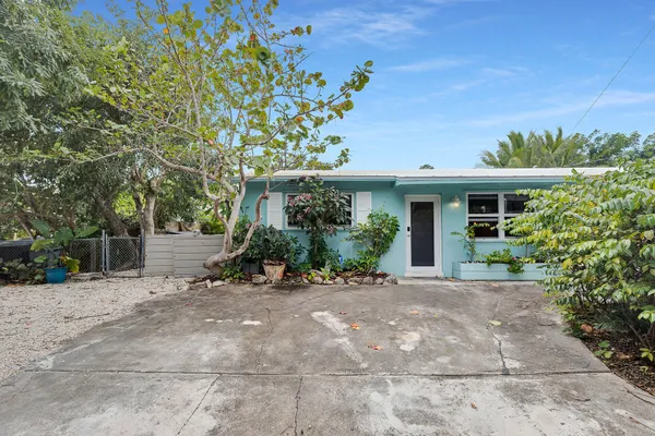 a living room with furniture and painting on the wall
