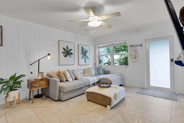 a kitchen with stainless steel appliances granite countertop a refrigerator a stove and white cabinets with wooden floor