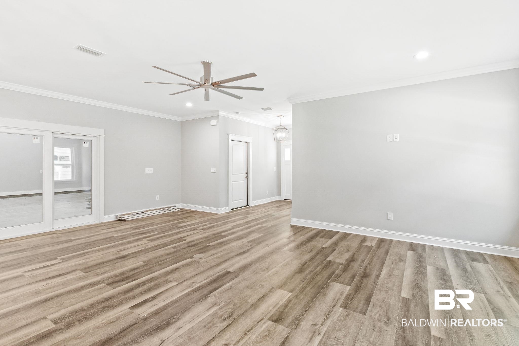 12441 Reunion Place Foley, AL 36535 - Photo 8 of 31 Unfurnished room featuring crown molding, ceiling fan, and light hardwood / wood-style floors