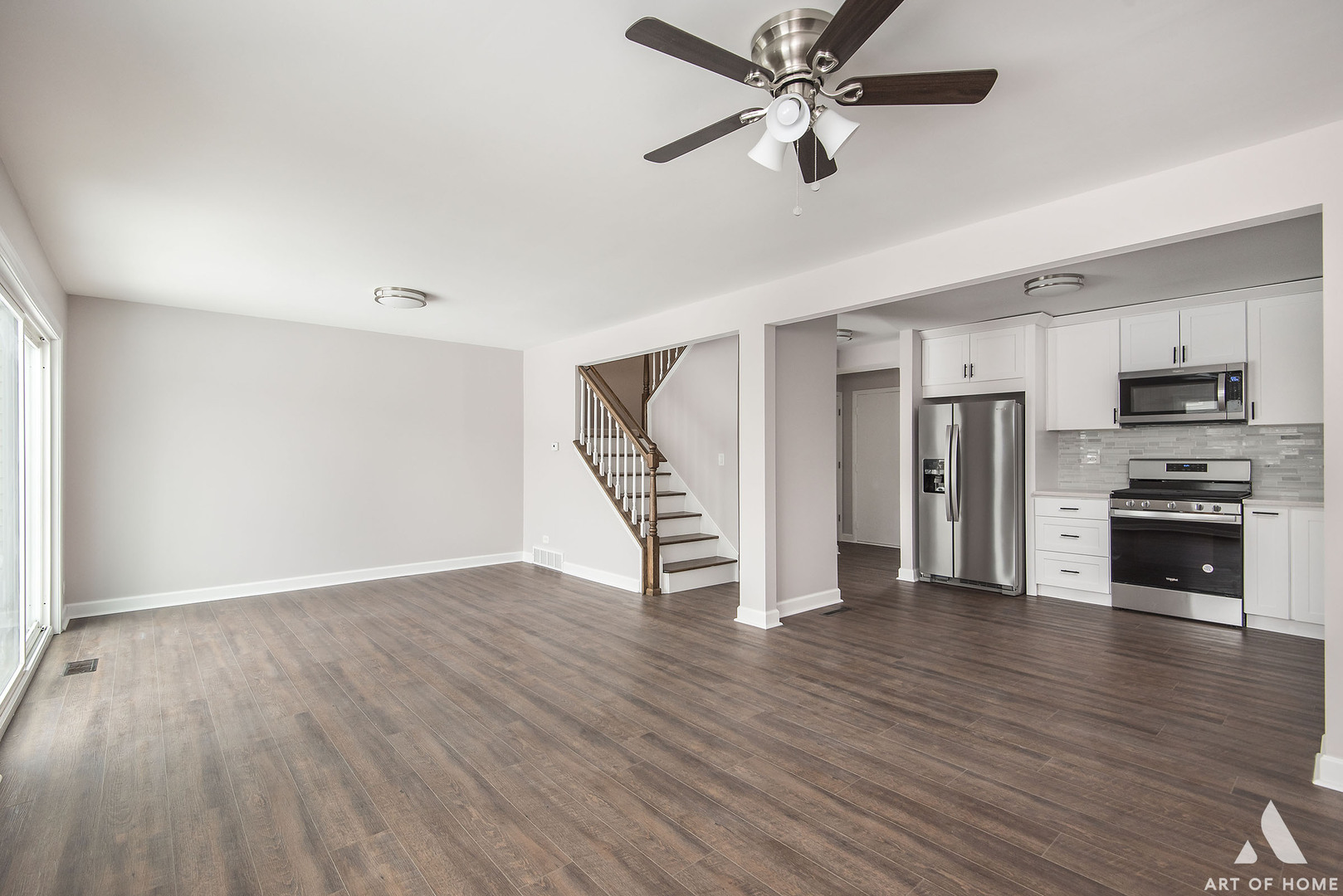 513 Monroe Road Bolingbrook, IL 60440 - Photo 2 of 21 a view of an empty room with wooden floor a ceiling fan and a window