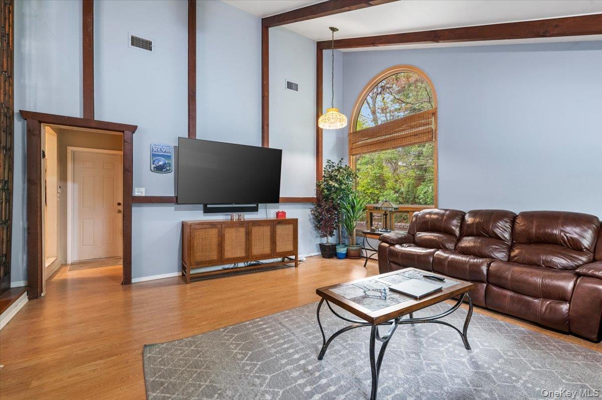 6 Apex Road Melville, NY 11747 - Photo 10 of 50 a living room with furniture a window and a flat screen tv