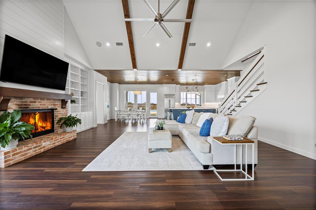 4421 Azalea Way Midlothian, TX 76065 - Photo 6 of 38 Living room with dark wood-style flooring, high vaulted ceiling, a brick fireplace, recessed lighting, and beam ceiling