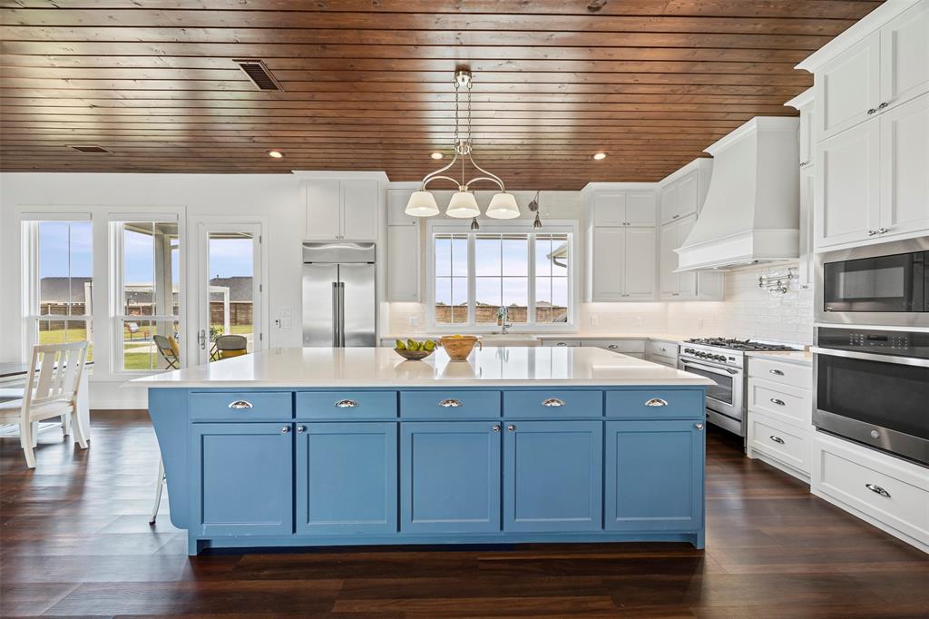 4421 Azalea Way Midlothian, TX 76065 - Photo 9 of 38 Kitchen with blue cabinetry, backsplash, wooden ceiling, built in appliances, and a center island