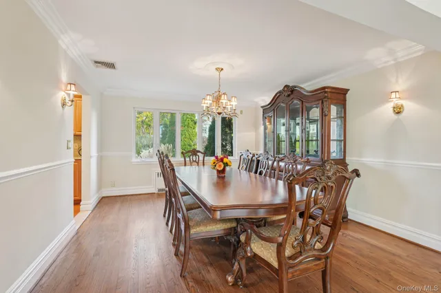 a dining room with furniture window and wooden floor