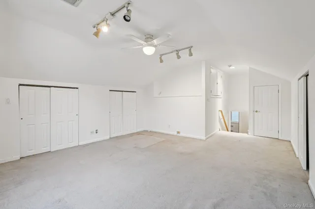 a view of an empty room with a ceiling fan