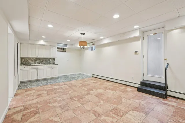 a view of an empty room with a kitchen