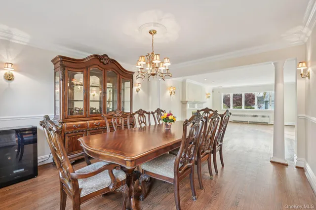 a dining room with furniture a chandelier and wooden floor