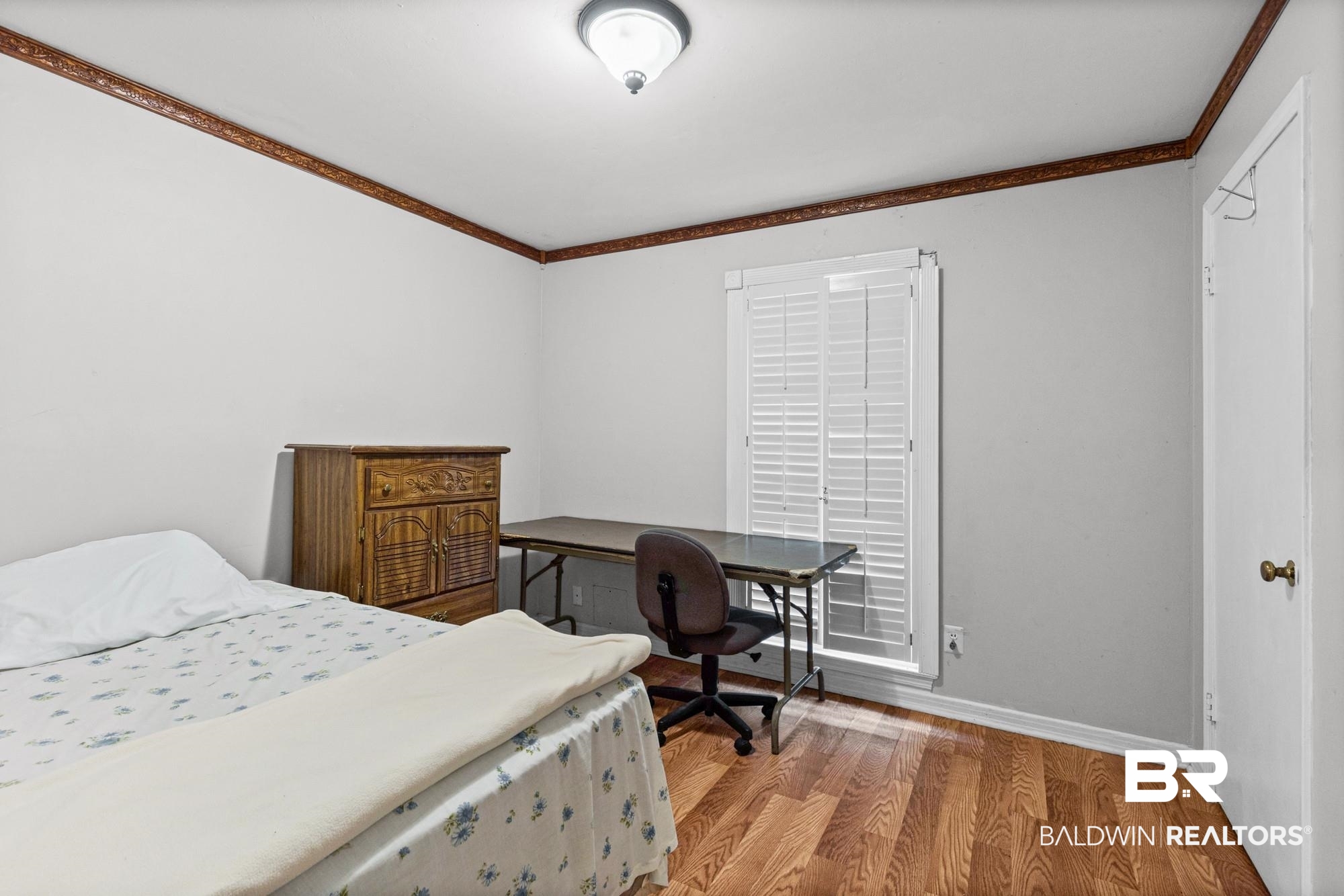 5510 Richmond Road Mobile, AL 36608 - Photo 11 of 21 Bright interior space featuring wood-finish flooring, white walls, and decorative wood crown molding