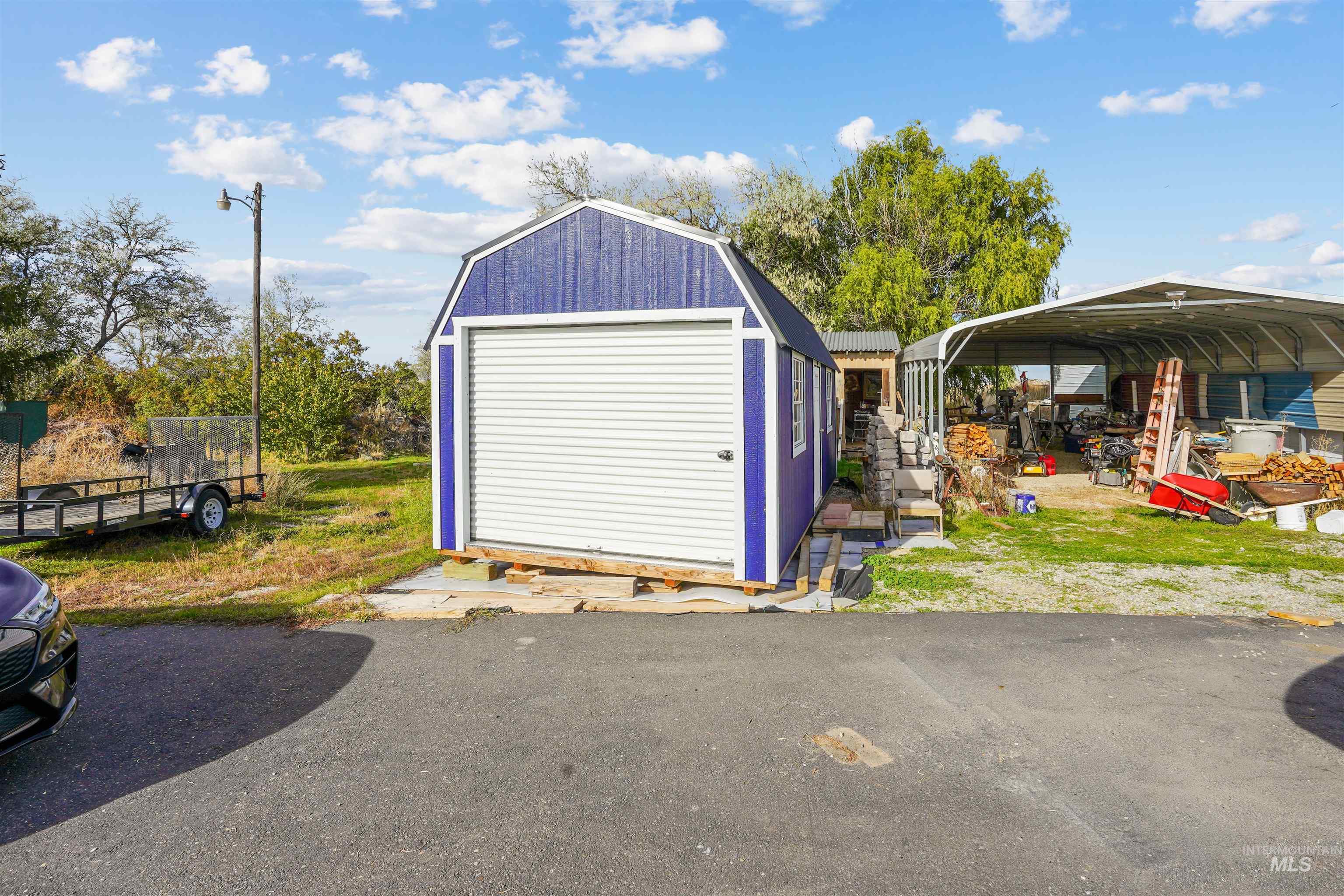 1176 East 600 North Rupert, ID 83350 - Photo 16 of 19 Garage featuring a shed and a carport