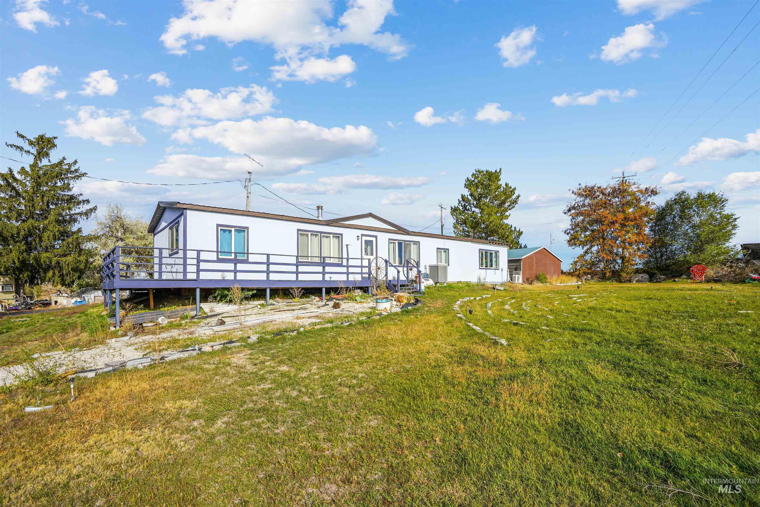 1176 East 600 North Rupert, ID 83350 - Photo 8 of 19 Back of property featuring a yard and a deck