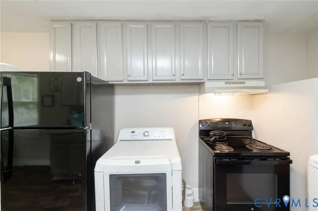 a kitchen with a refrigerator and a stove