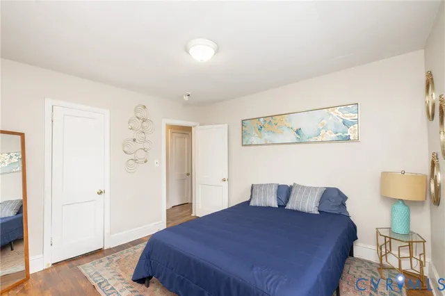 a bedroom with a bed and wooden floor