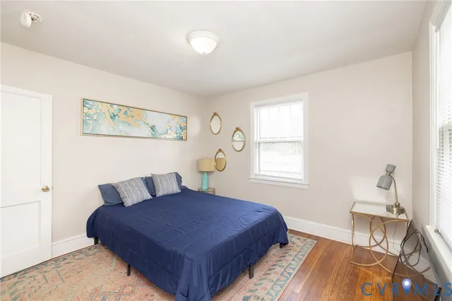 a spacious bedroom with a bed and chair