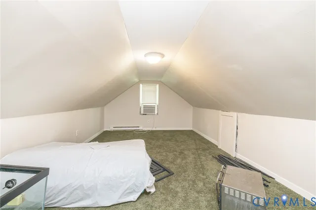 a bedroom with a bed and a night stand