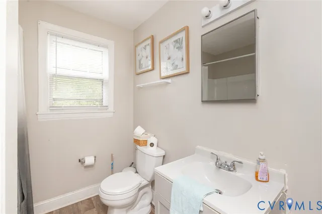 a white toilet sitting next to a bathroom sink