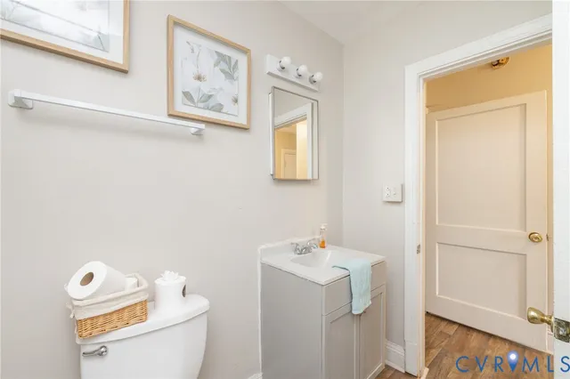 a bathroom with a sink mirror and toilet