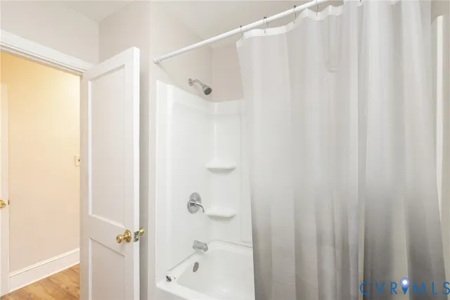 a bathroom with a shower and a tub