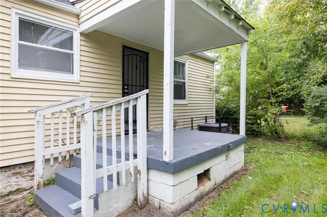 a view of house with yard and deck