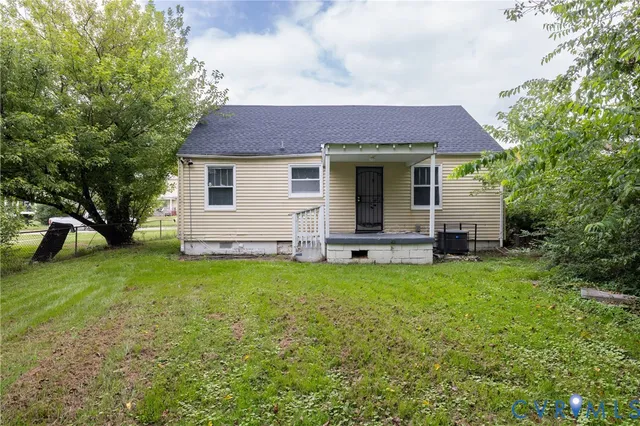a backyard of a house with table and chairs