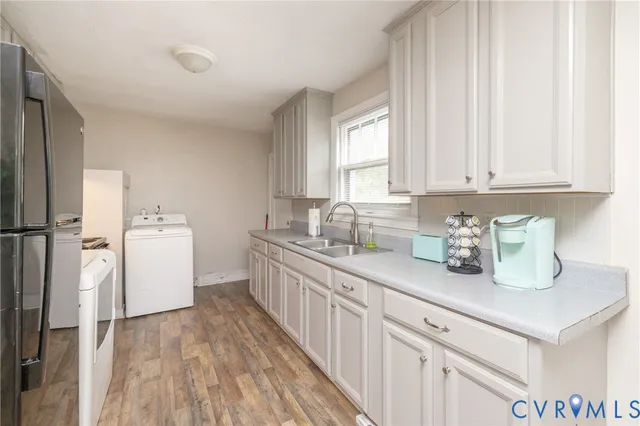 a kitchen with sink a cabinets and wooden floor