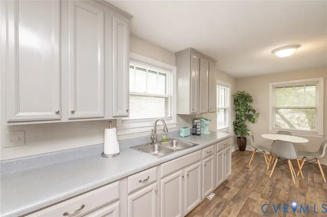 a kitchen with a sink and a white cabinets