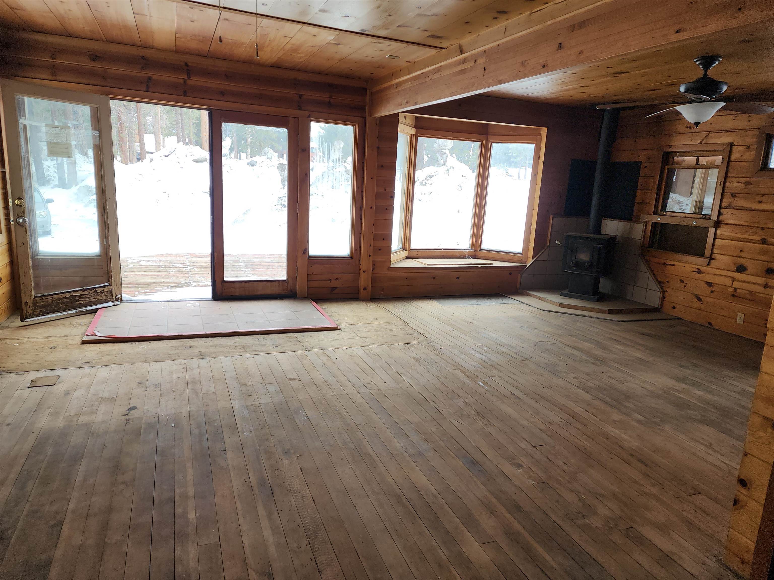 72 Laurel Mountain Road Mammoth Lakes, CA 93546 - Photo 7 of 27 an empty room with wooden floor and windows