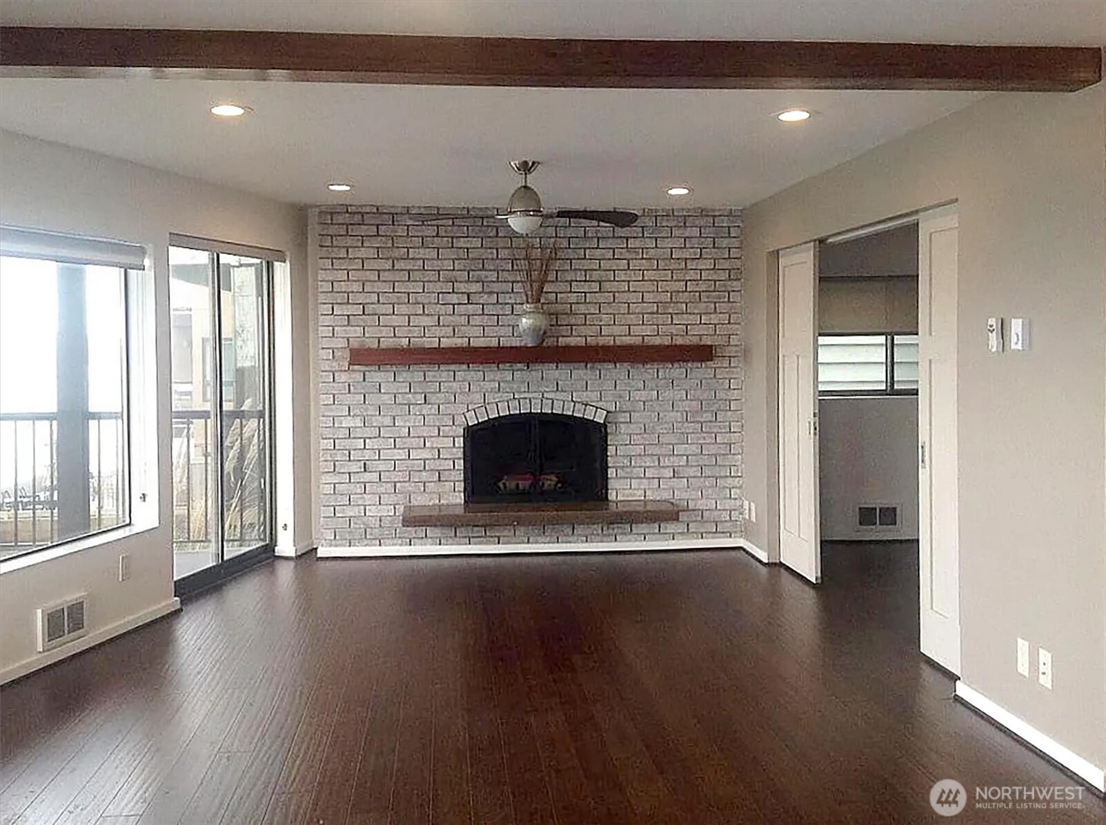 4131 Beach Drive Southwest Seattle, WA 98116 - Photo 15 of 40 a living room with a fireplace and wooden floor