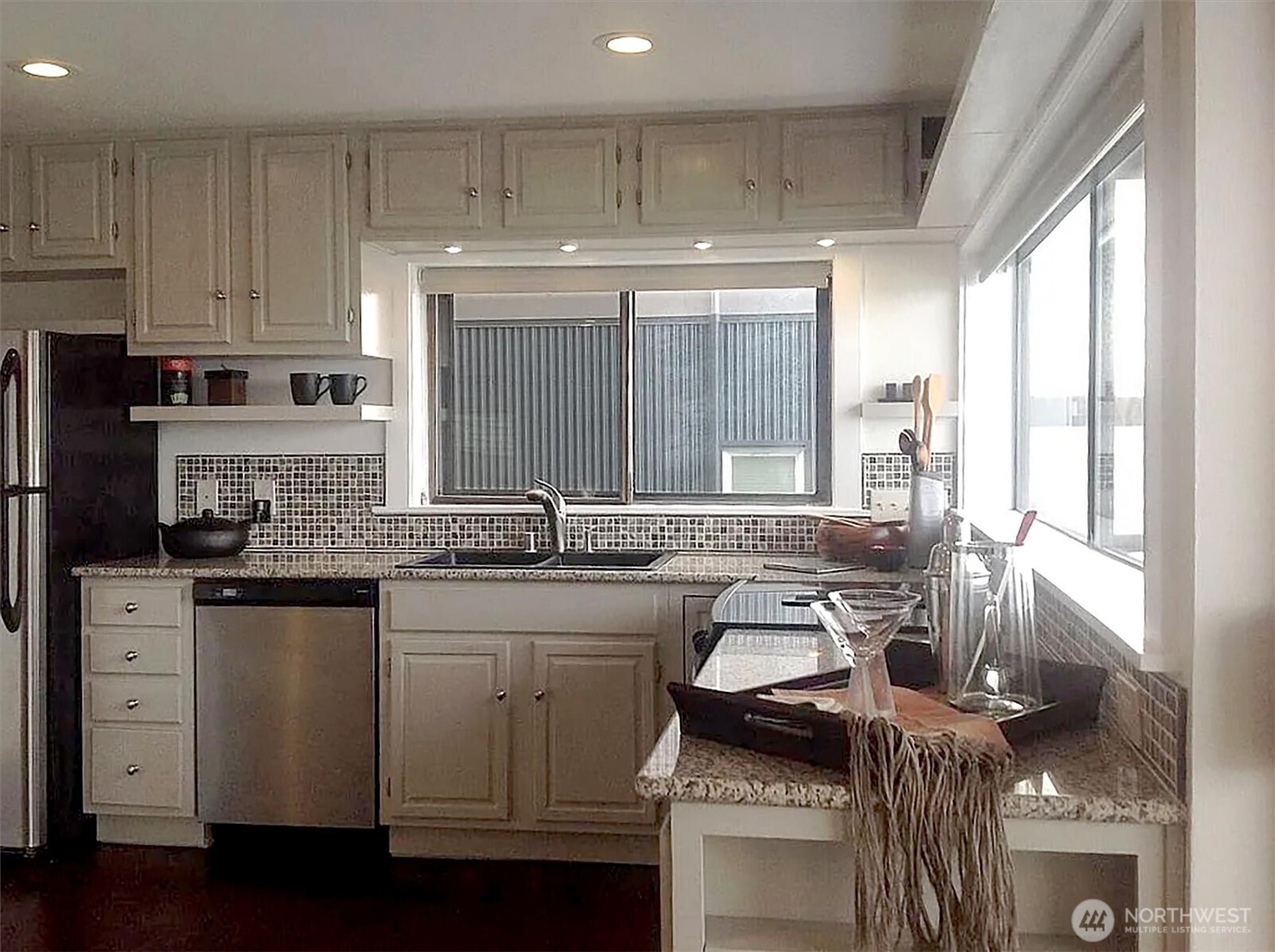 4131 Beach Drive Southwest Seattle, WA 98116 - Photo 16 of 40 a kitchen with stainless steel appliances granite countertop a sink stove and cabinets