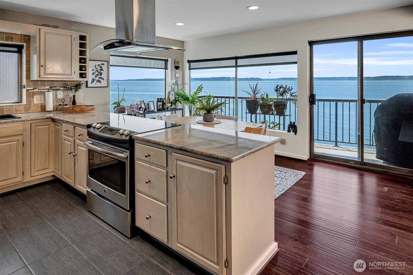 4131 Beach Drive Southwest Seattle, WA 98116 - Photo 22 of 40 a kitchen with stainless steel appliances granite countertop a stove and a sink