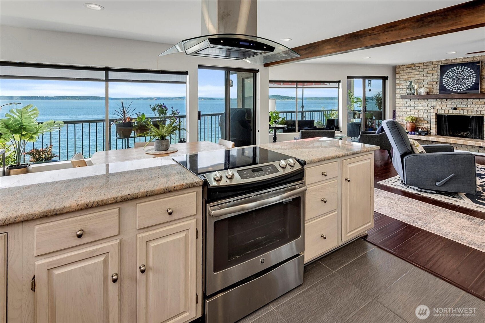 4131 Beach Drive Southwest Seattle, WA 98116 - Photo 24 of 40 a kitchen with stainless steel appliances granite countertop a stove a sink and a granite counter tops