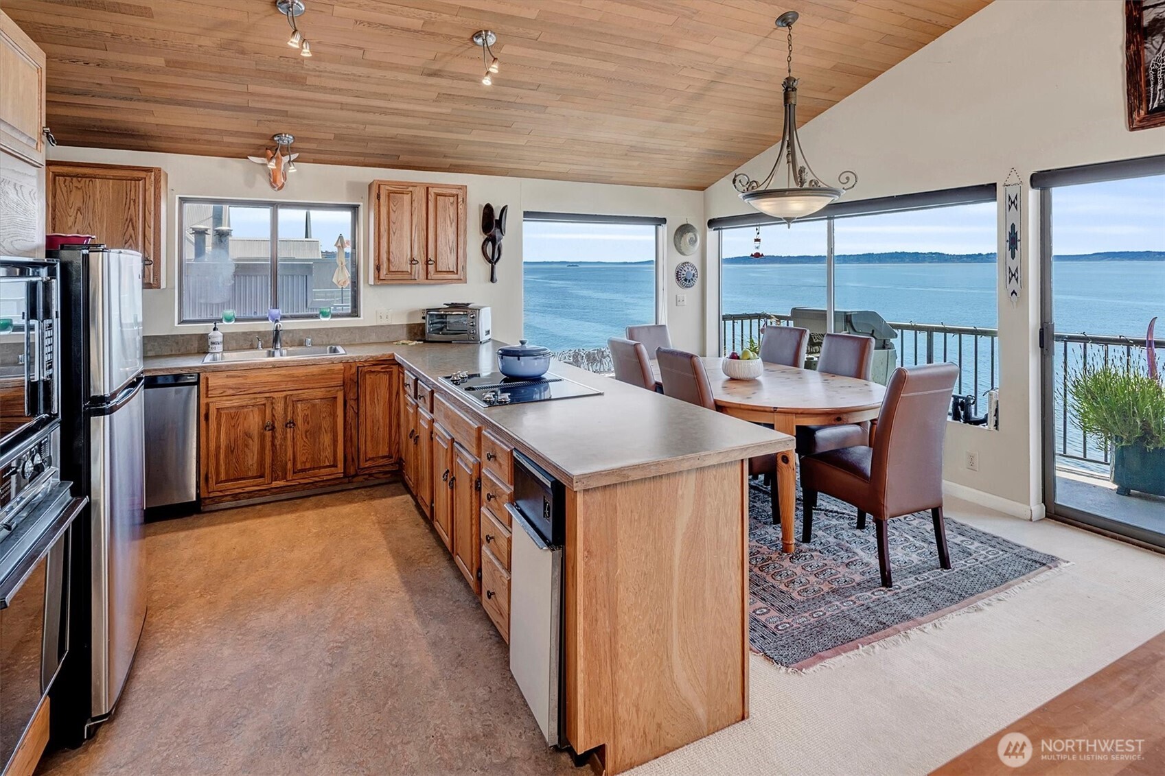 4131 Beach Drive Southwest Seattle, WA 98116 - Photo 33 of 40 a kitchen with stainless steel appliances granite countertop a sink stove and refrigerator