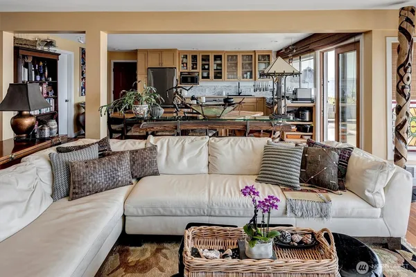 a living room with a fireplace and wooden floor