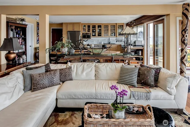 a living room with a fireplace and wooden floor