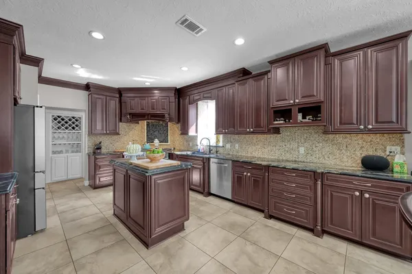 a bathroom with a granite countertop shower a sink and a mirror