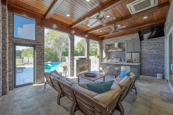 a view of a house with a yard patio and fire pit