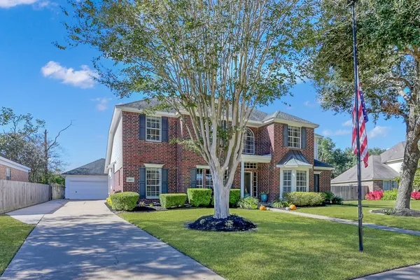 a dining room with furniture a chandelier and wooden floor