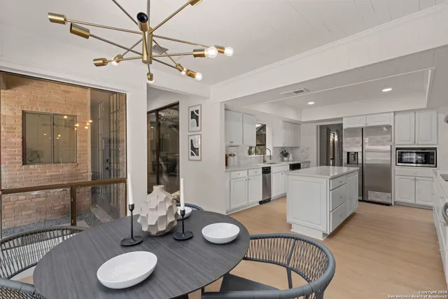 a large kitchen with a table and chairs