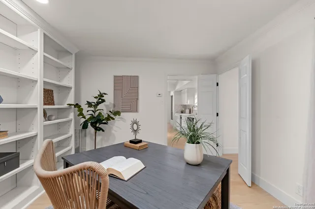 a table with a potted plant and a chair