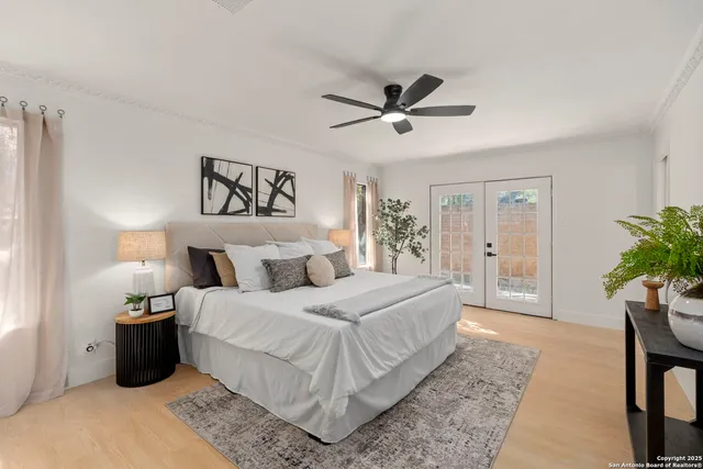 a bedroom with a large bed and a chandelier