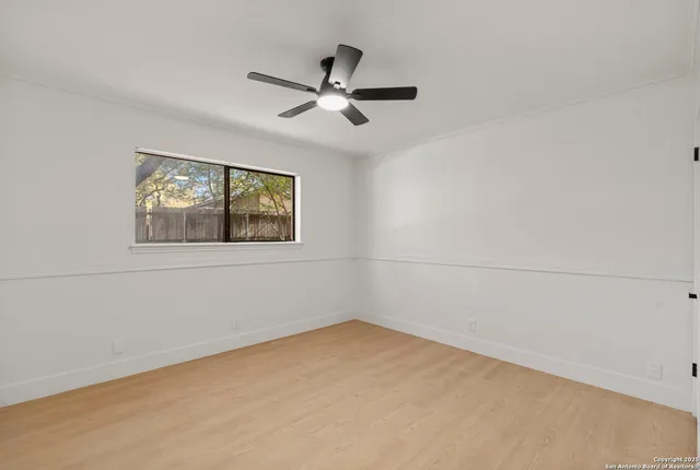 a view of empty room with wooden floor