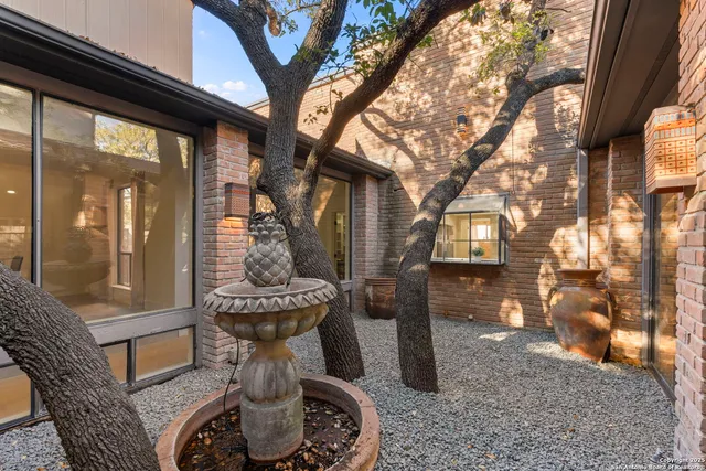 a view of a porch with furniture and floor to ceiling window