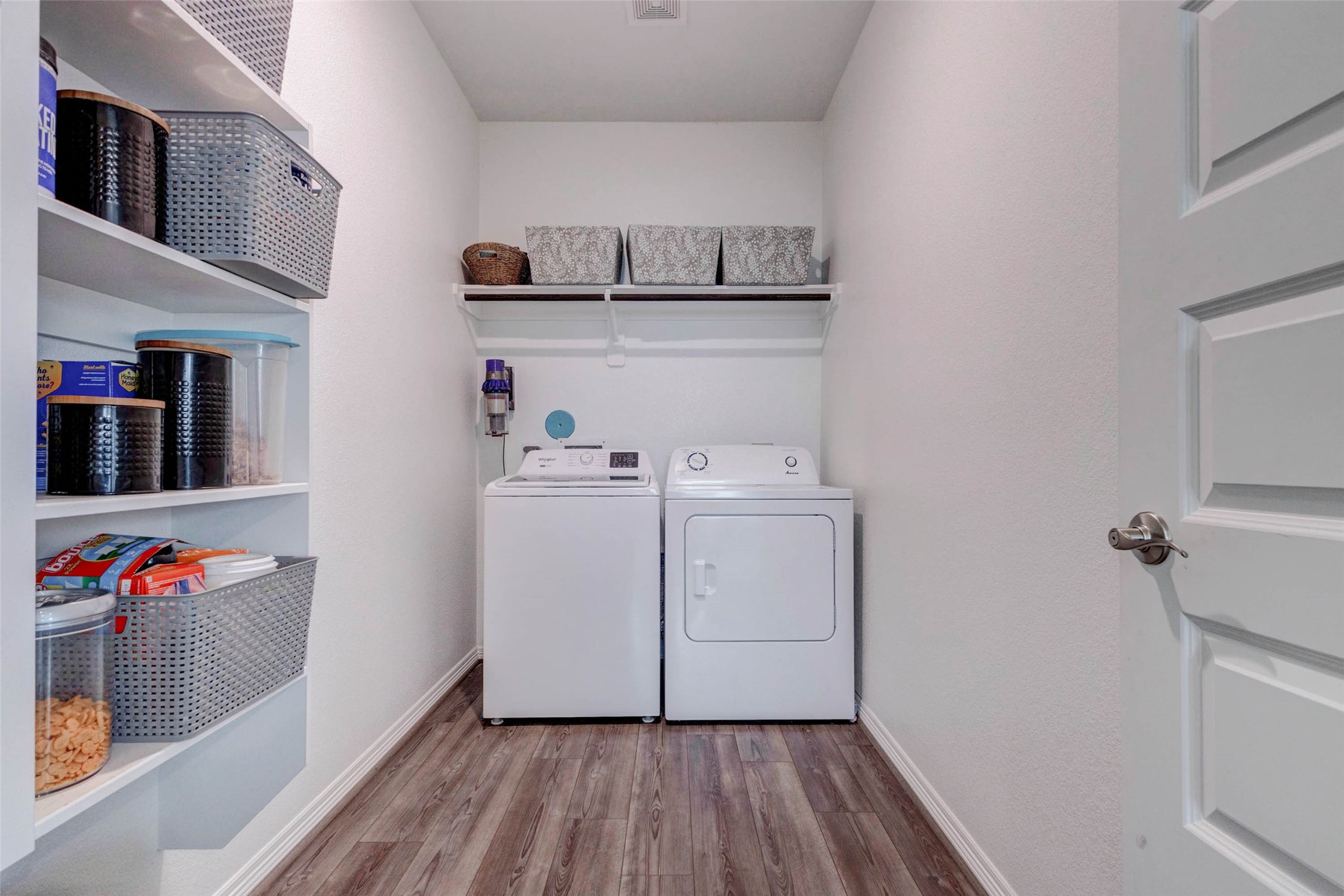 32418 Fly Fish Way Fulshear, TX 77441 - Photo 22 of 40 The dedicated laundry room offers generous space for full size side by side washer and dryer connections, overhead shelving for storage, and a built-in shelving unit on the side wall that doubles perfectly as a pantry or additional storage area to keep everyday essentials organized and within easy reach.