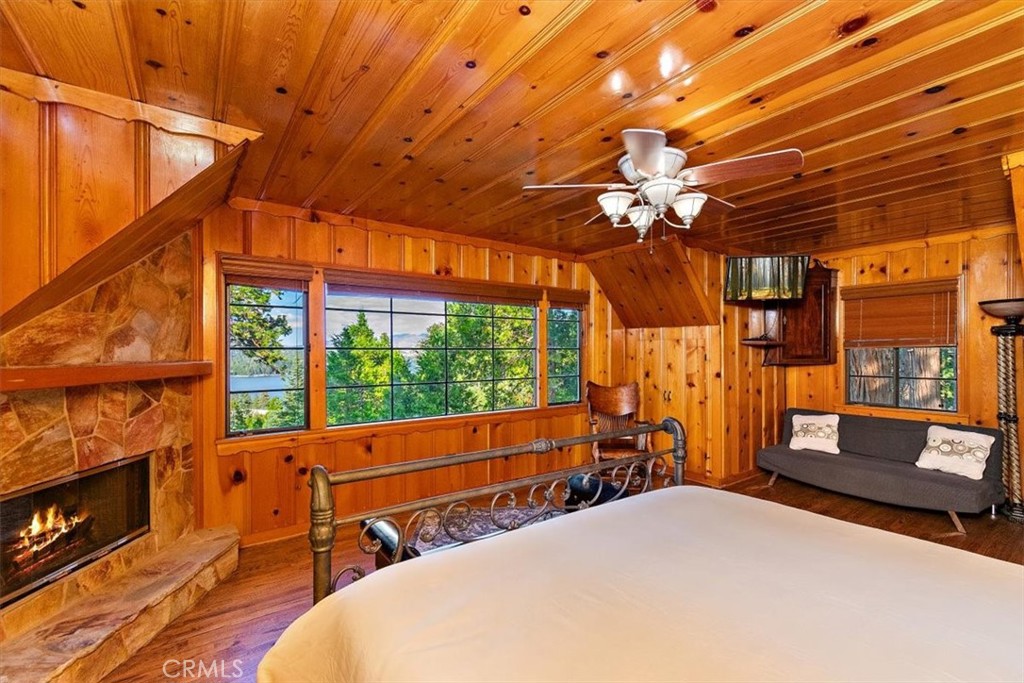 329 Summit Road Lake Arrowhead, CA 92352 - Photo 29 of 61 a bedroom with furniture and a chandelier